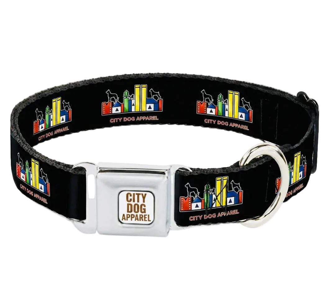 A black dog collar with a silver metal buckle and D-ring, featuring a repeating multicolor cityscape pattern with the text 'CITY DOG APPAREL' on a light gray background.