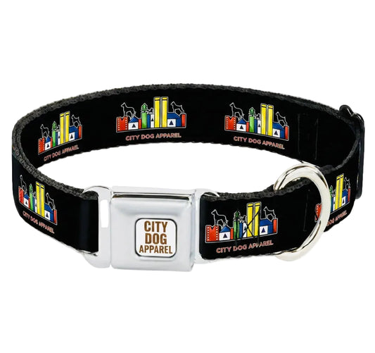 A black dog collar with a silver metal buckle and D-ring, featuring a repeating multicolor cityscape pattern with the text 'CITY DOG APPAREL' on a light gray background.